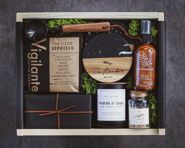 Gift set with coffee products and decorative items on a dark background