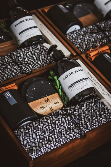 Closing gift boxes with dish soap, custom engraved wooden coasters and kitchen towel