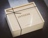 Wooden box with personalization on a dark surface